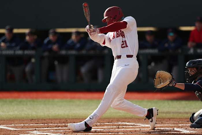 Alabama right fielder Andrew Pinckney (21) swings the bat in the Crimson Tide's 12-3 victory over the Richmond Spiders on Feb. 17, 2023 at Sewell-Thomas Stadium in Tuscaloosa, Ala.